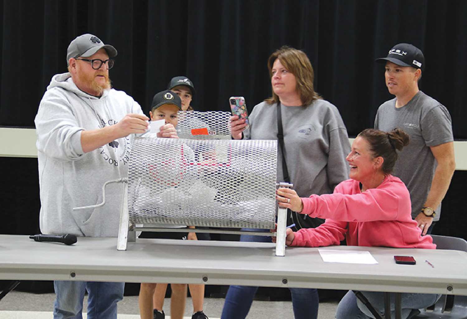 The $100,000 grand prize ticket being pulled for the Lucky Lottery. From left are Kirby Fowler, Declan Hanna and Brynn Hanna (behind the drum), Sherry Fowler, Clayton Lawless and Andrea Logan.